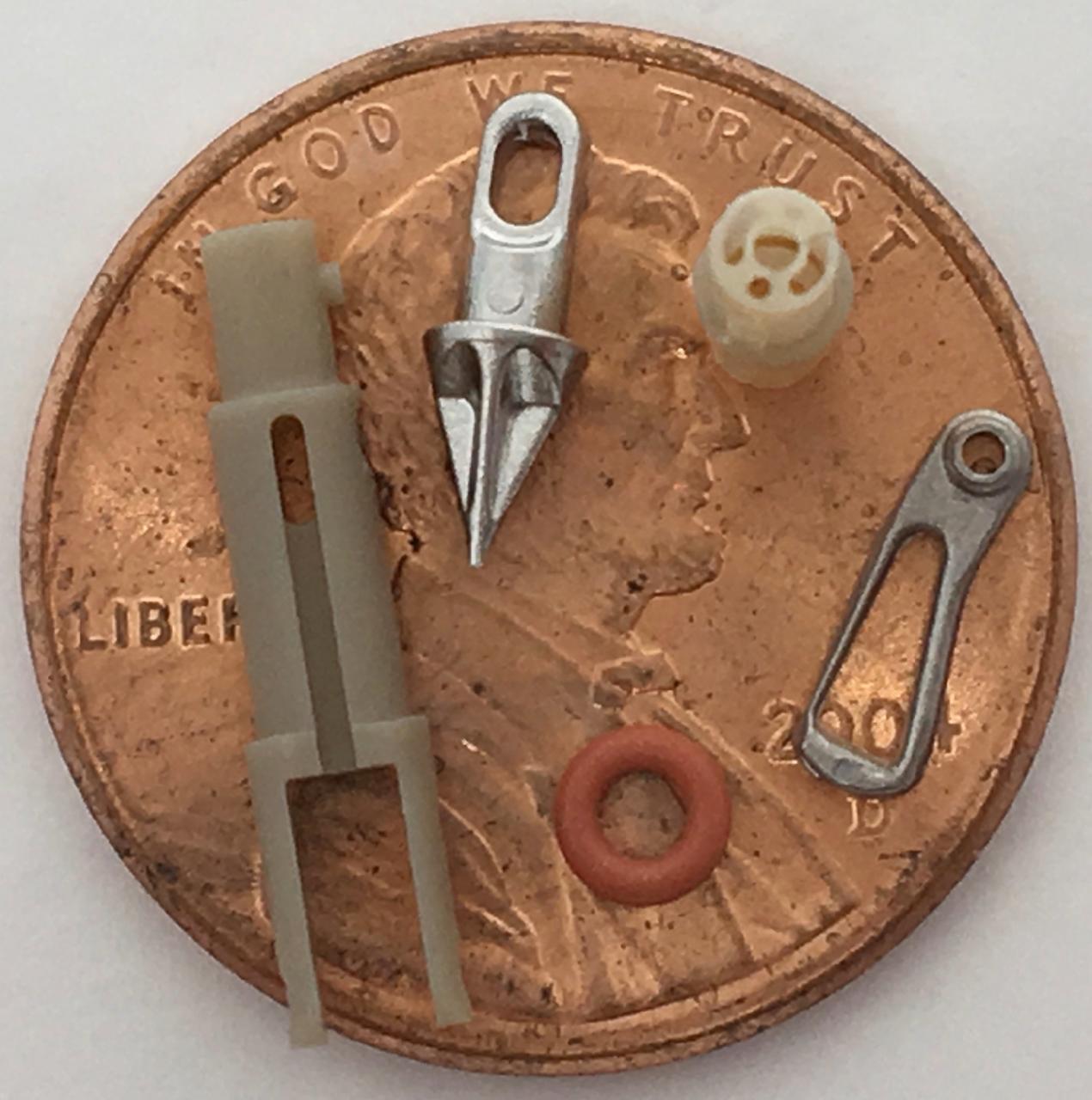 Micro machined PEEK prototype next to quarter