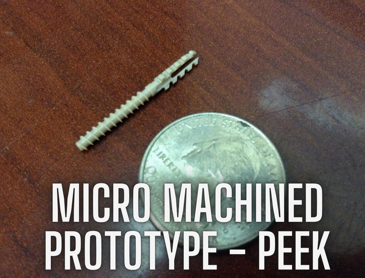 PEEK spinal prototype next to quarter